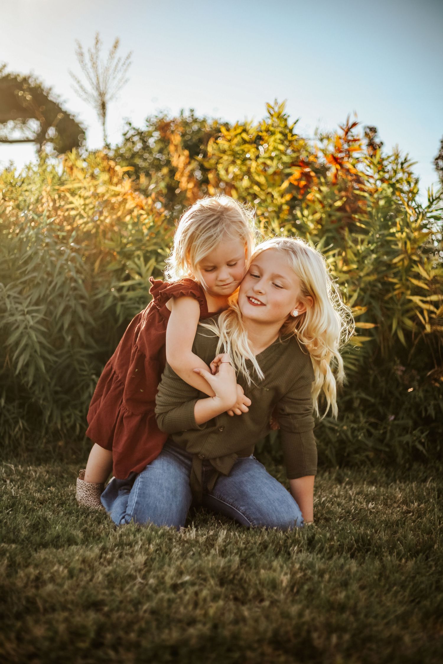 Playful outdoor family moment captured during golden sunset.