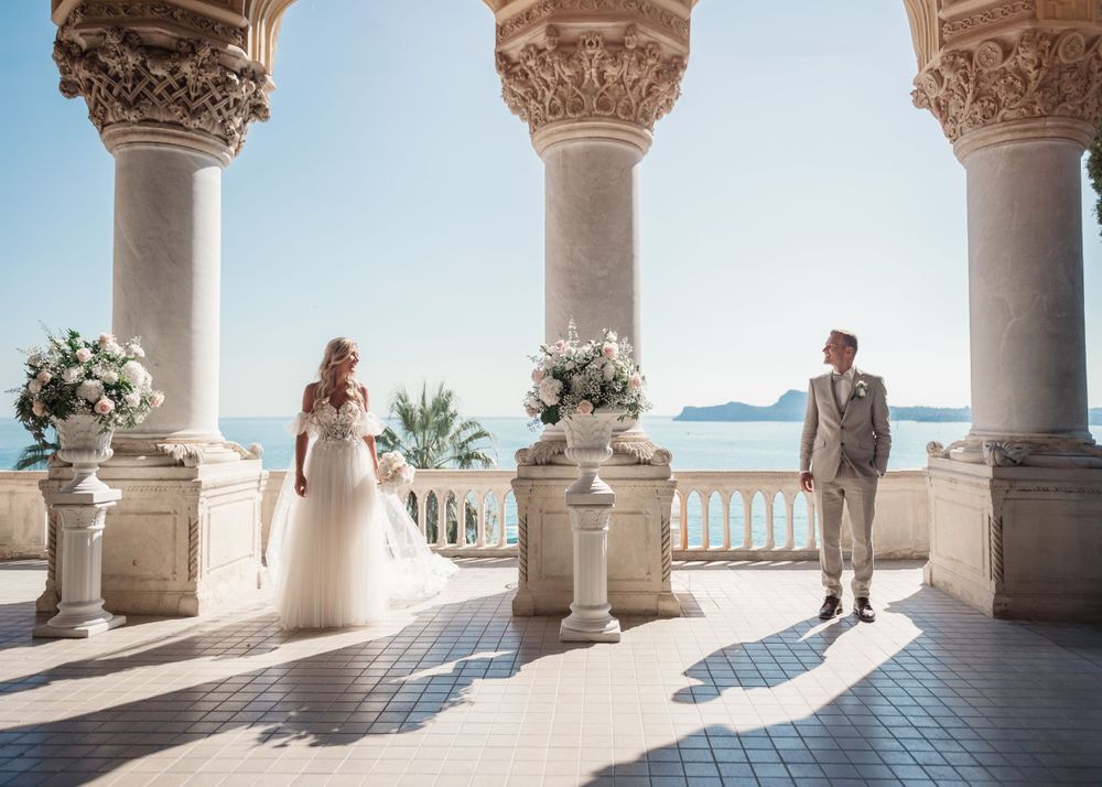 Sun-drenched Mediterranean style colonnade with white pillars and ocean views.