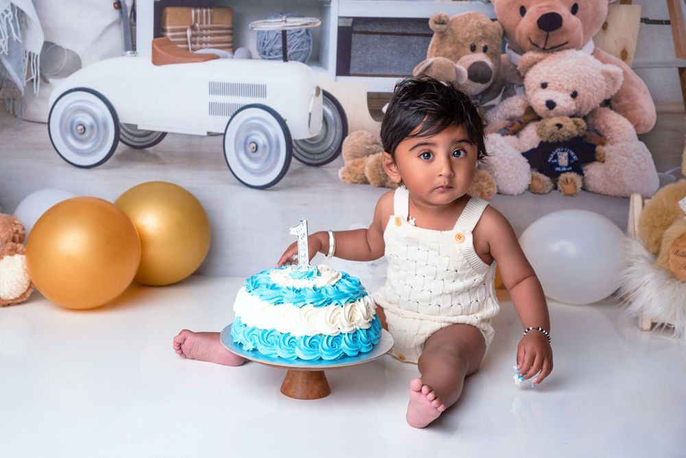 Baby boy smashing birthday cake during cake smash session in Wolverhampton