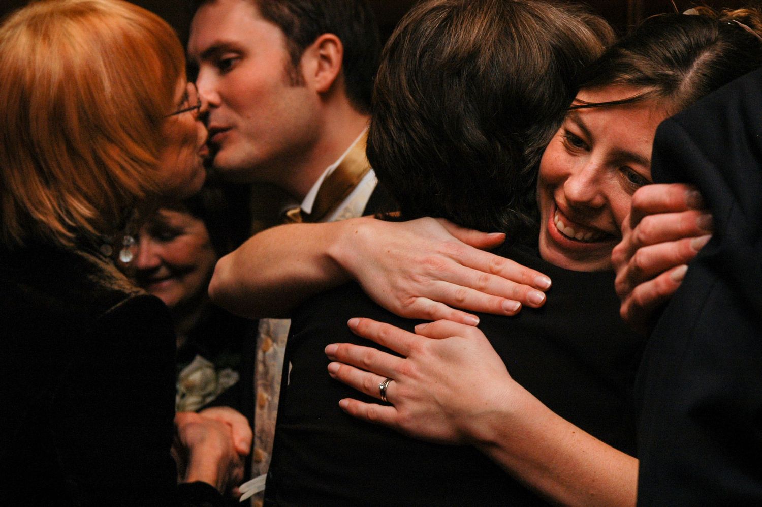 bride and groom embrace their wedding guests during a line up