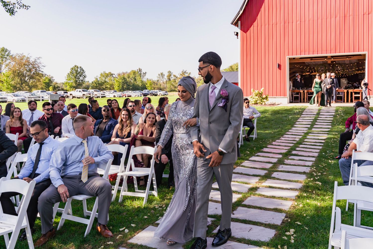 Groom escorting his mom to her seat for the ceremony - Blue Heron Barn