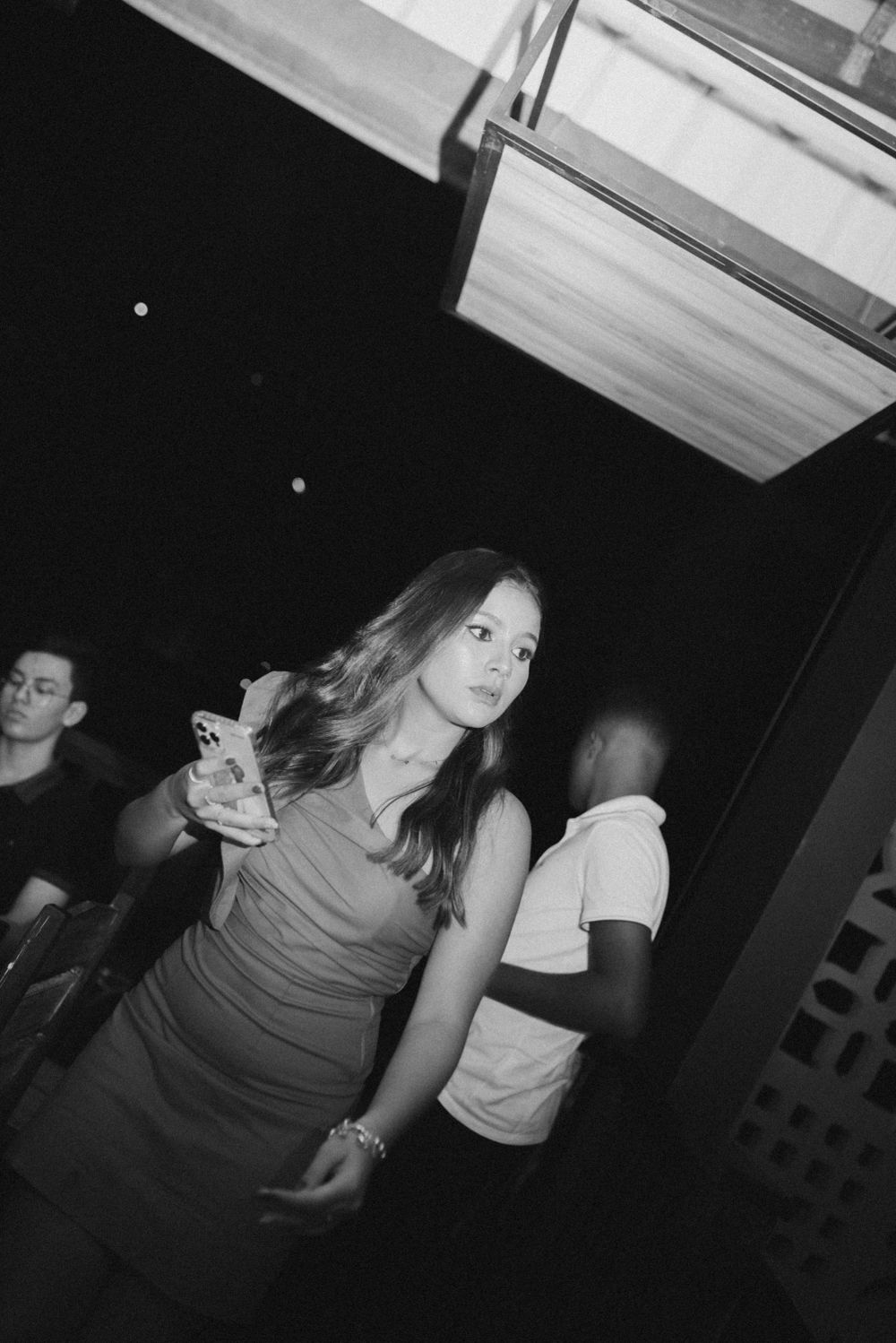 Black and white photo of people dancing at a nightclub.