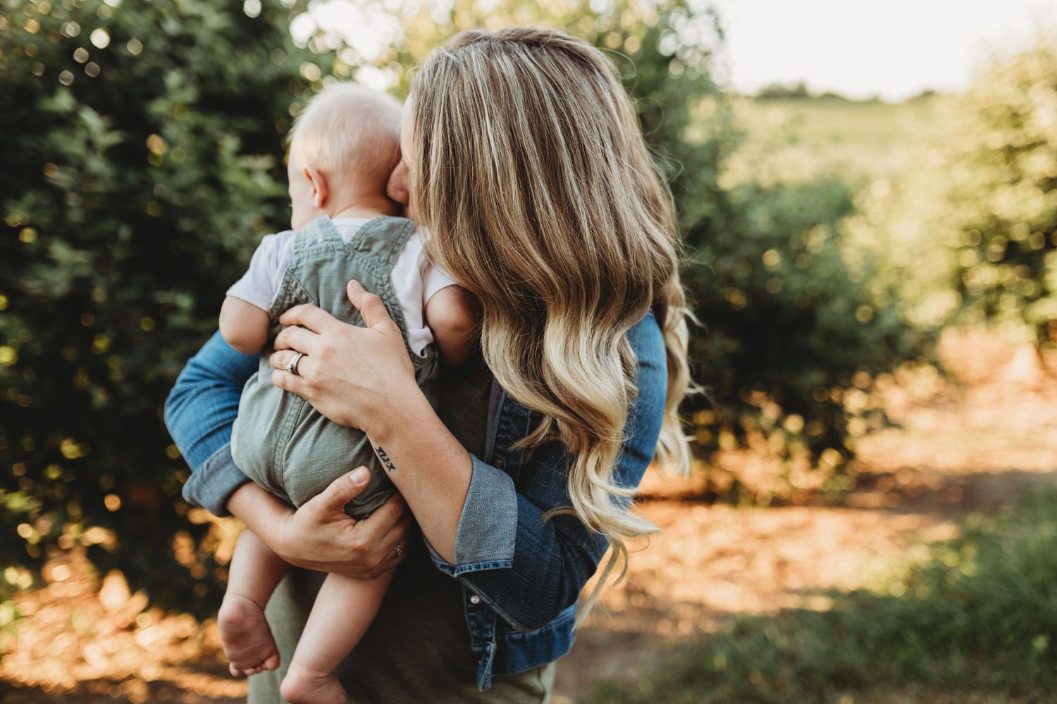 Mother snuggles her son at an orchard in Lancaster, PA