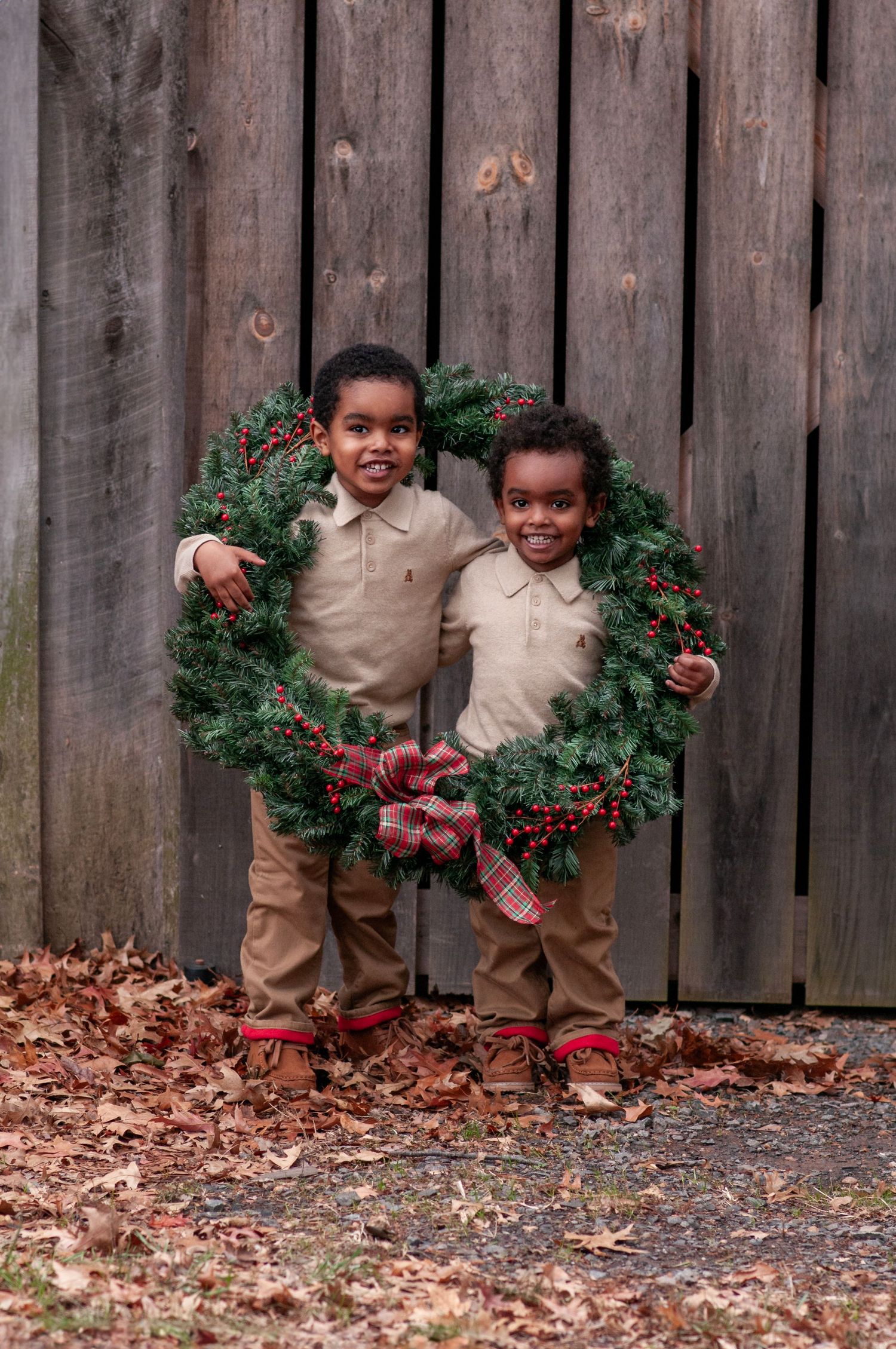 two toddler boys with a holiday wreath