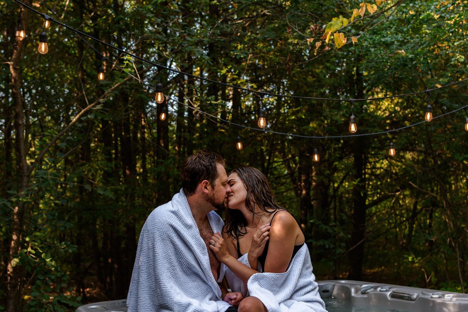 couple kissing on edge of a hot tub