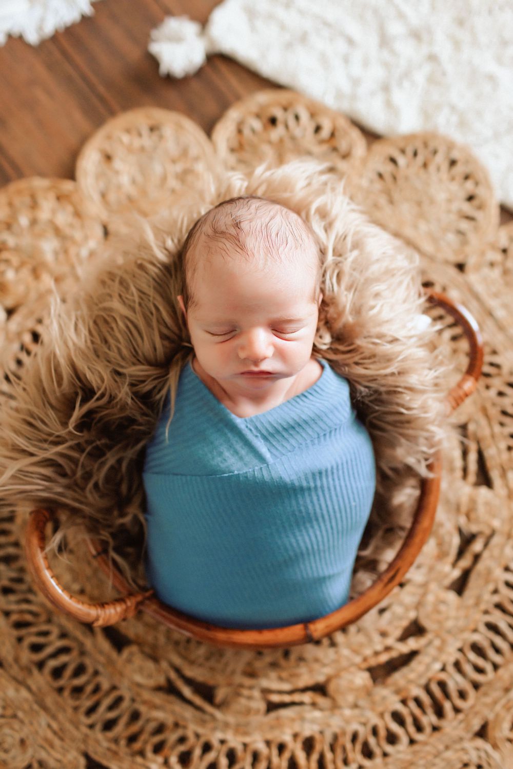 Newborn lifestyle session in Lincolnton NC with baby swaddled in neutrals