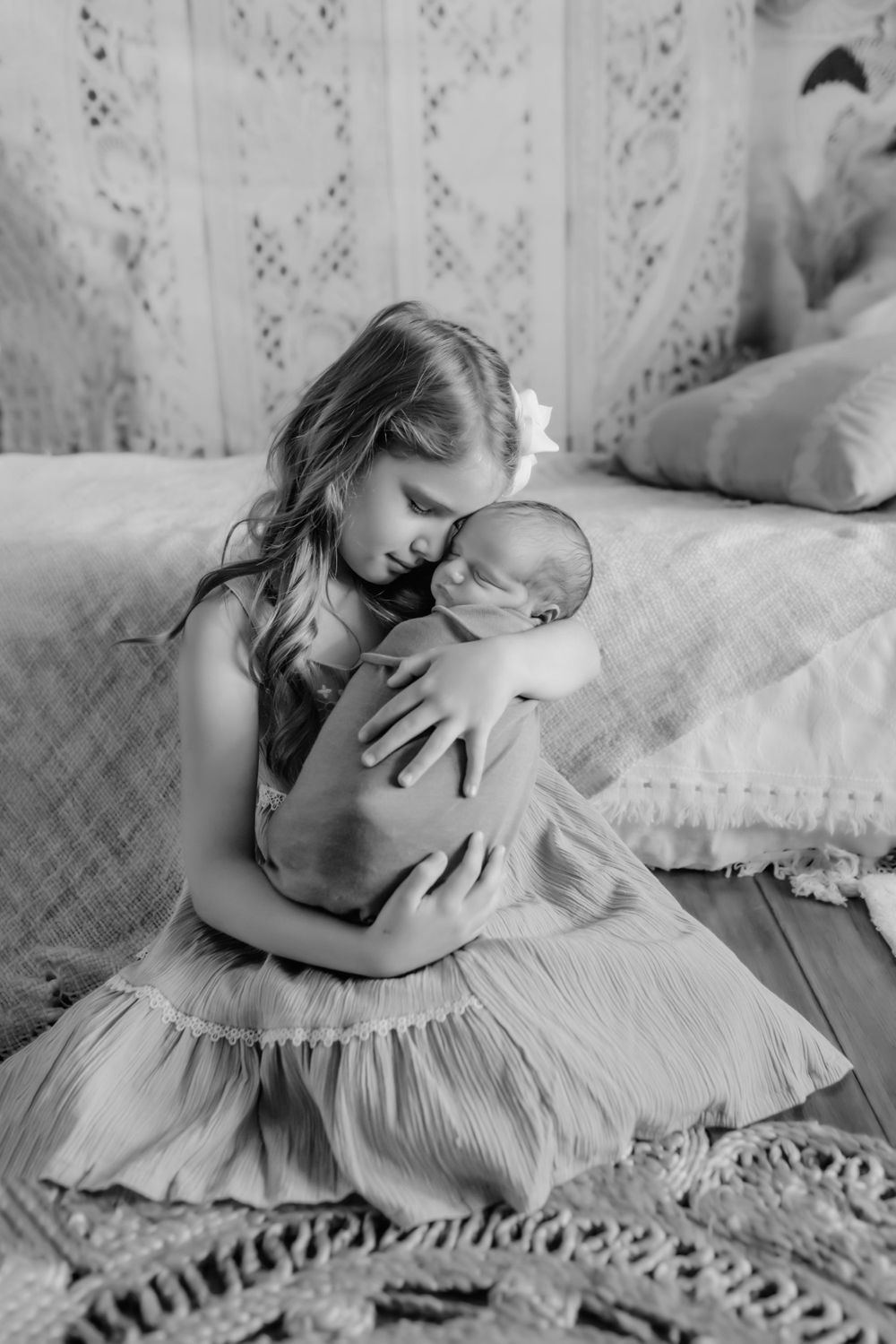 Candid family snuggles with newborn in Hickory NC home
