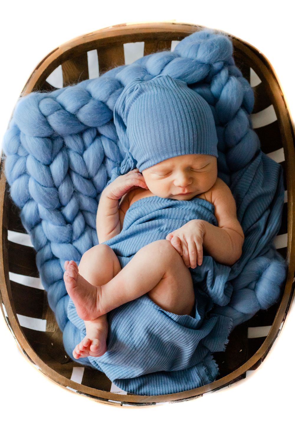 Newborn lifestyle session in Lincolnton NC with baby swaddled in neutrals