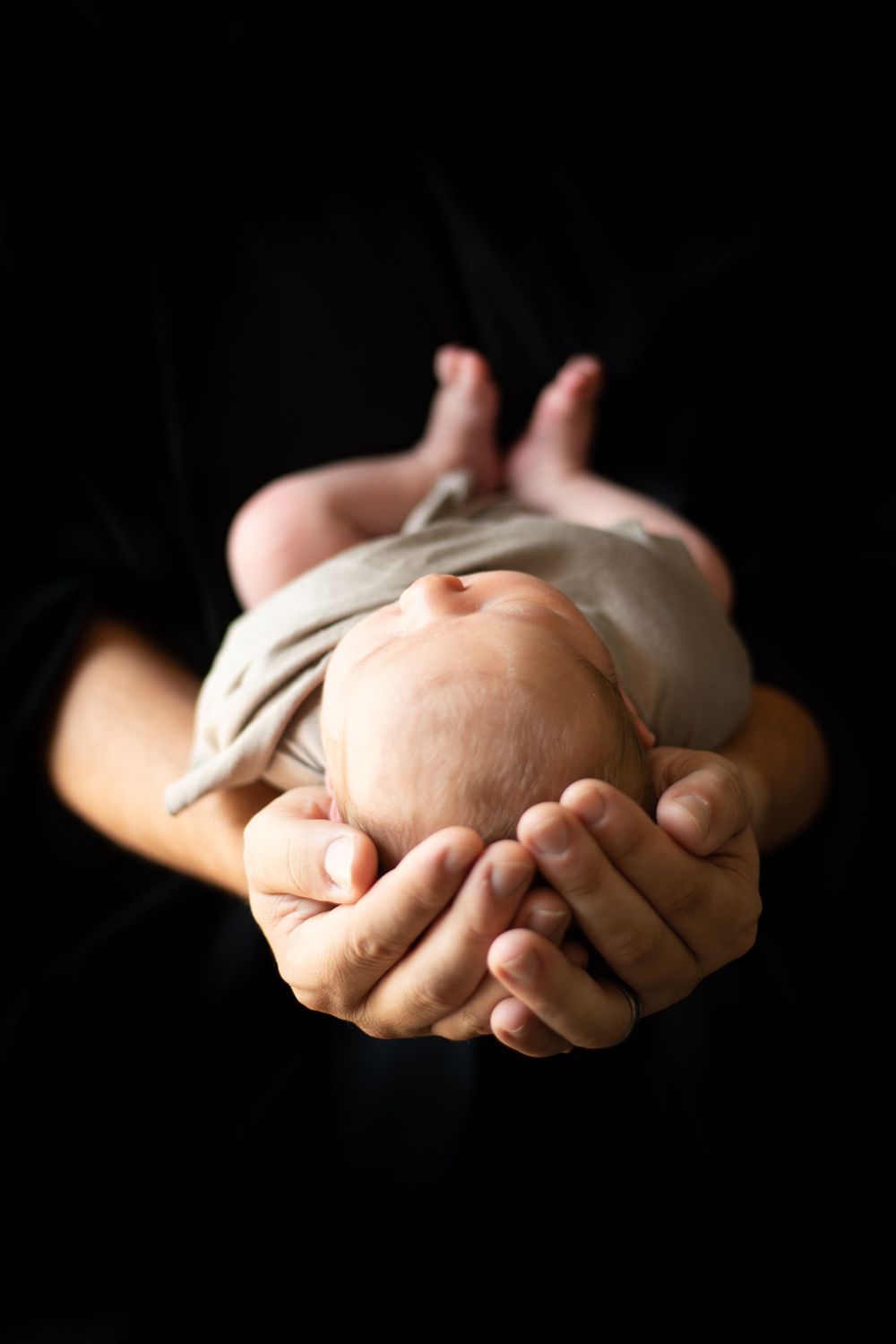 Newborn lifestyle session in Lincolnton NC with baby swaddled in neutrals
