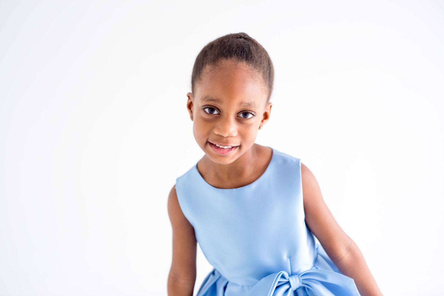 african american girl in a blue dress taking portraits in houston texas
