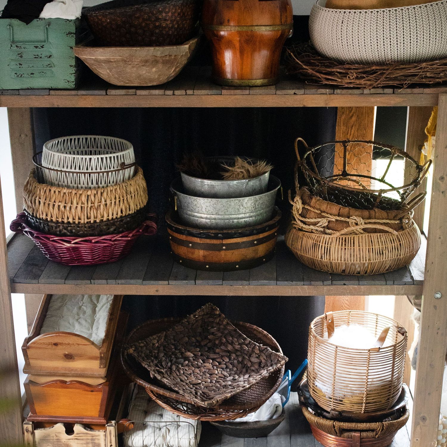 shelf with baskets, bed, bowls and other photo props