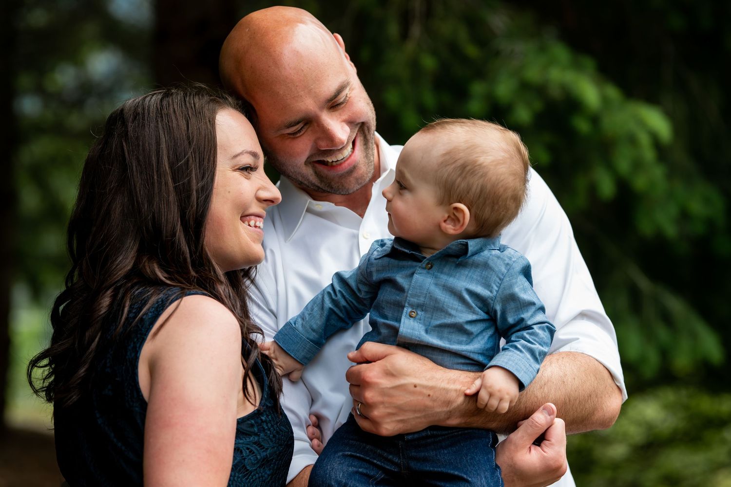 Family sharing joyful moments together outdoors in a natural garden setting.
