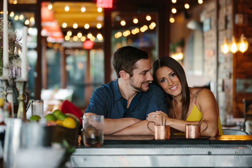 fiancé looking at his fiancee during engagement session at Finka restaurant in Miami