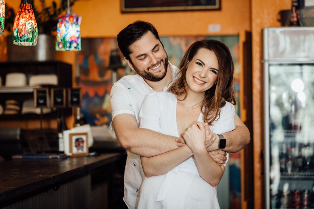 couple hugging each other during engagement session at Agustin Gainza Arts and Tavern in Miami Florida