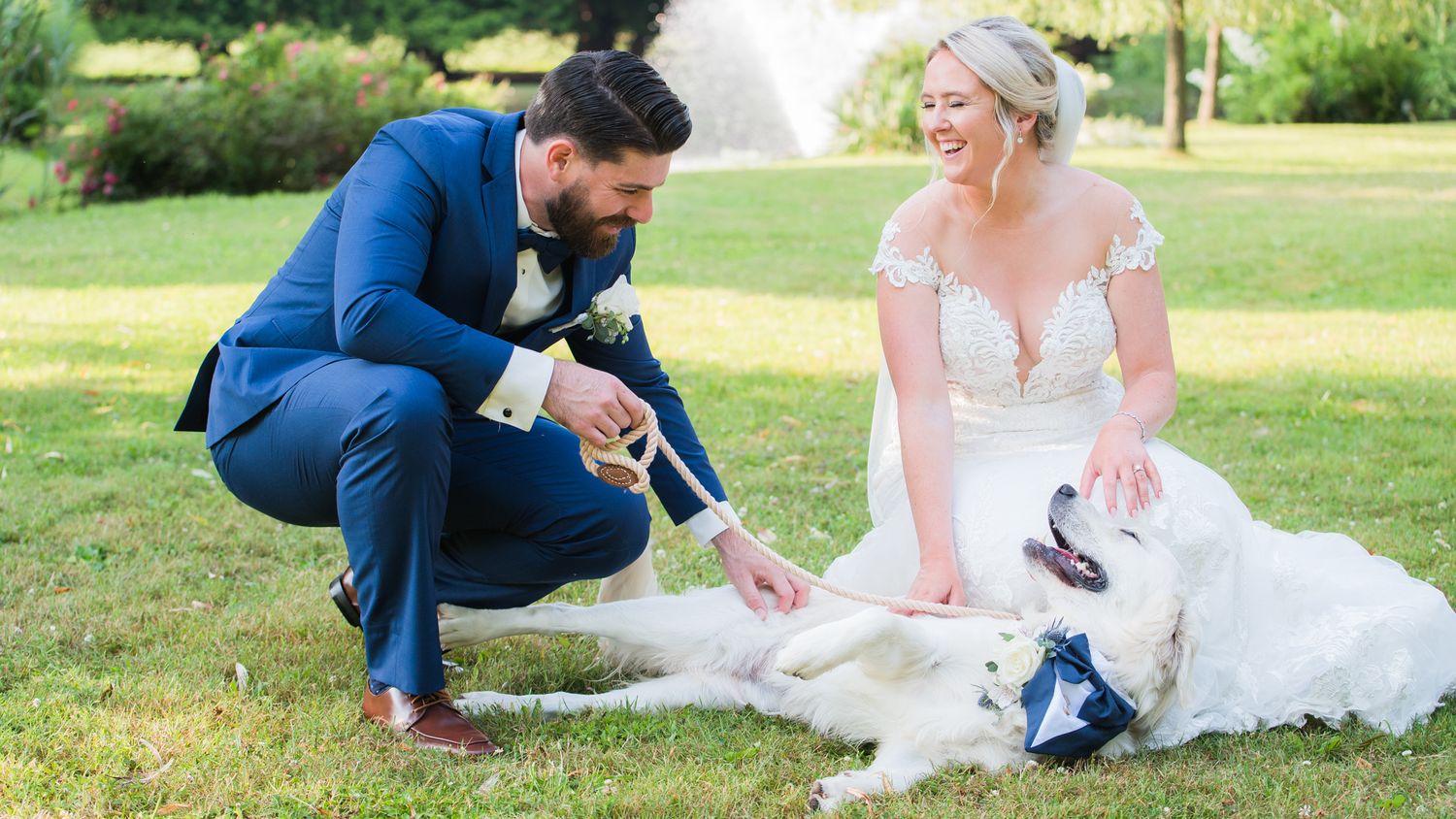 he newlyweds play with their dog before their wedding ceremony.