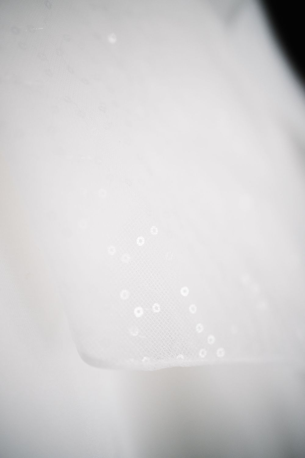 Abstract white fabric texture with soft bokeh light effects.