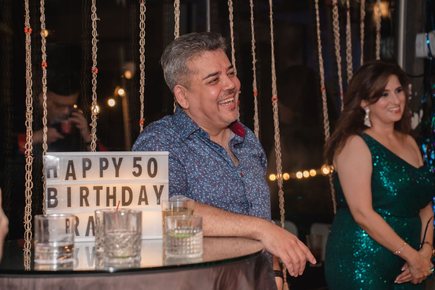 Festive 50th birthday celebration with illuminated decor and party lights.