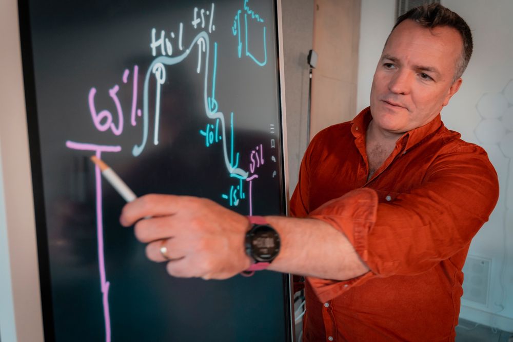 CEO man in red shirt point to digital black board