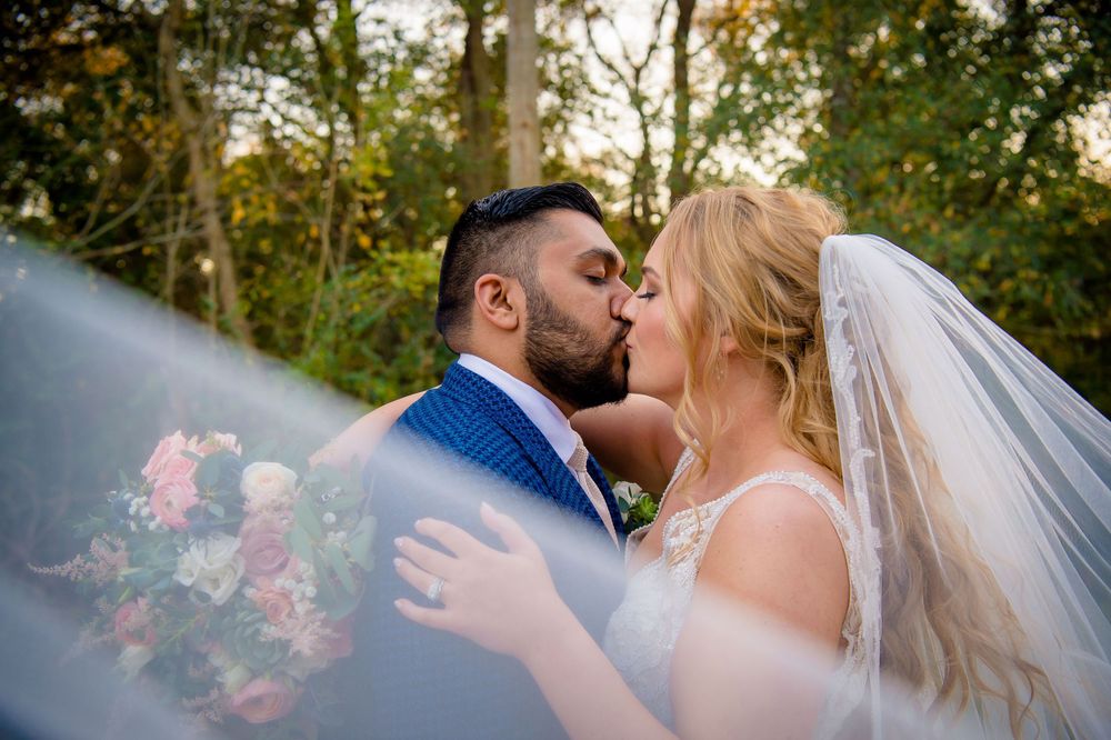 A romantic wedding moment captured outdoors with soft natural lighting.