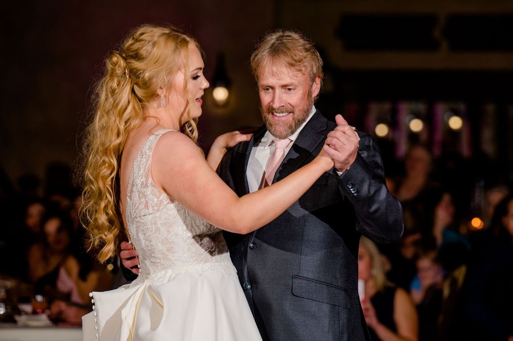 A joyful dance between wedding guests captured during the reception celebrations.