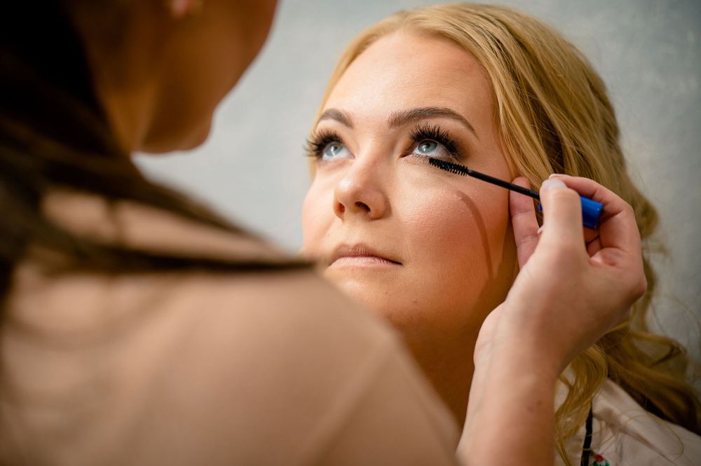 Close-up shot of mascara being applied during makeup application.