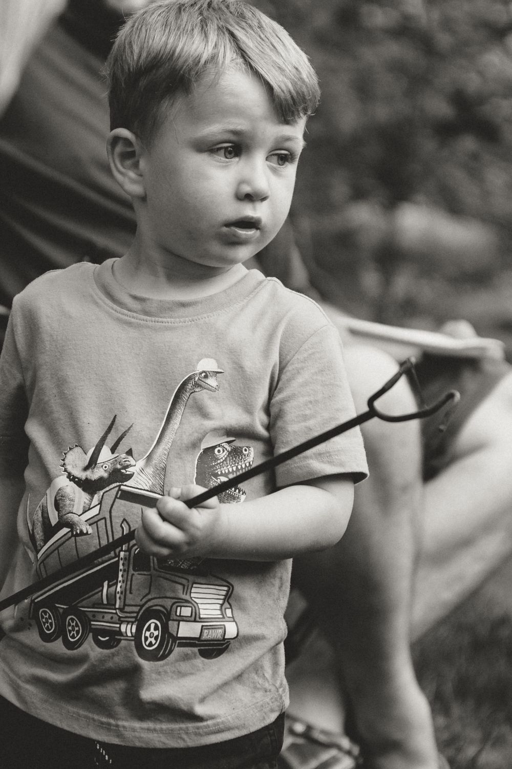 Child wearing t-shirt with train design in black and white portrait.