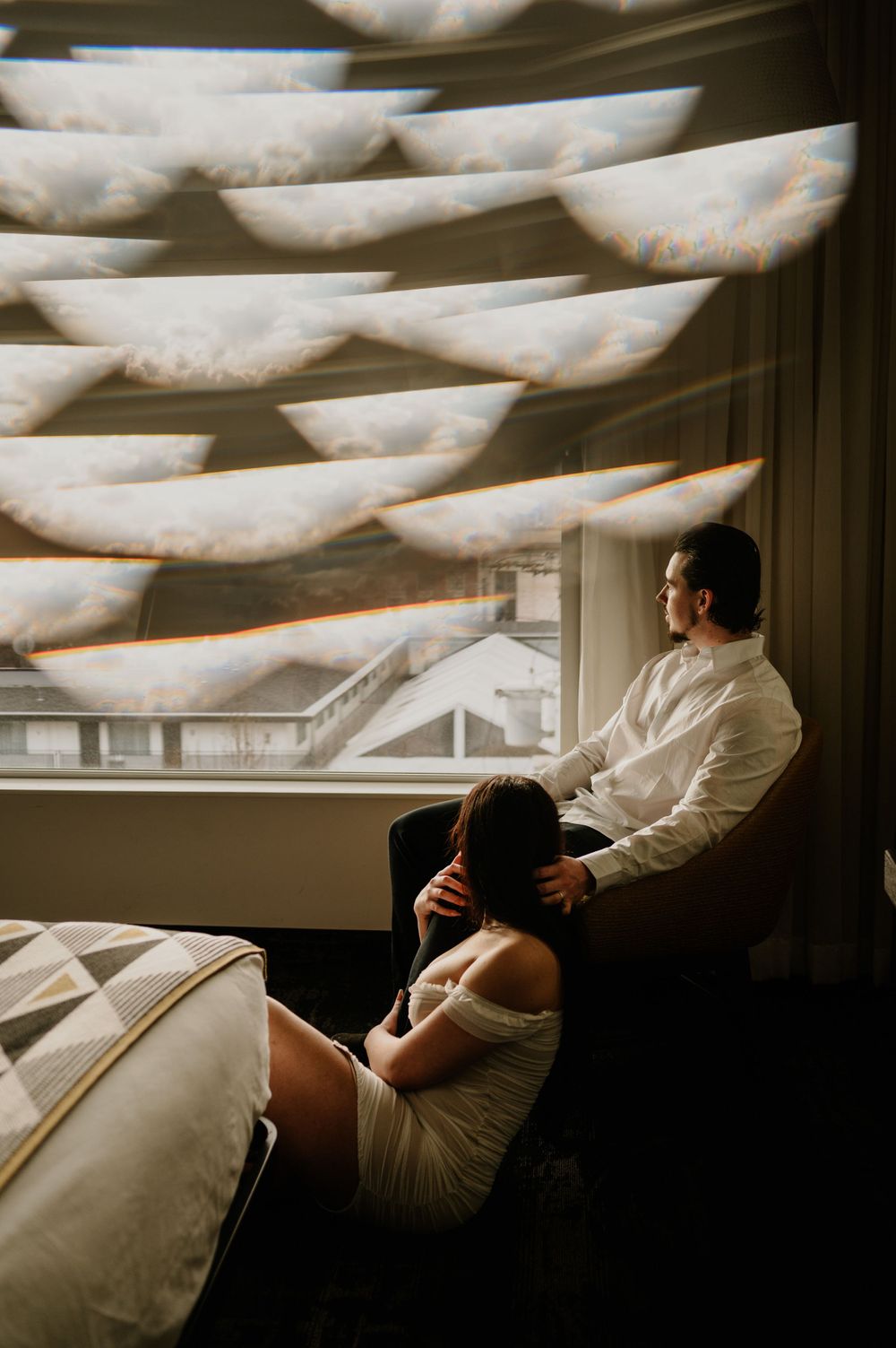 Artistic interior shot with geometric ceiling patterns and couple in white clothing.