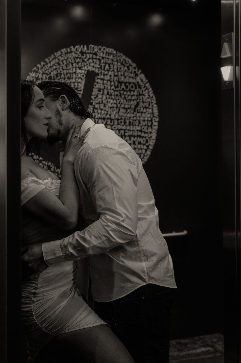 Artistic black and white shot of couple in intimate pose.