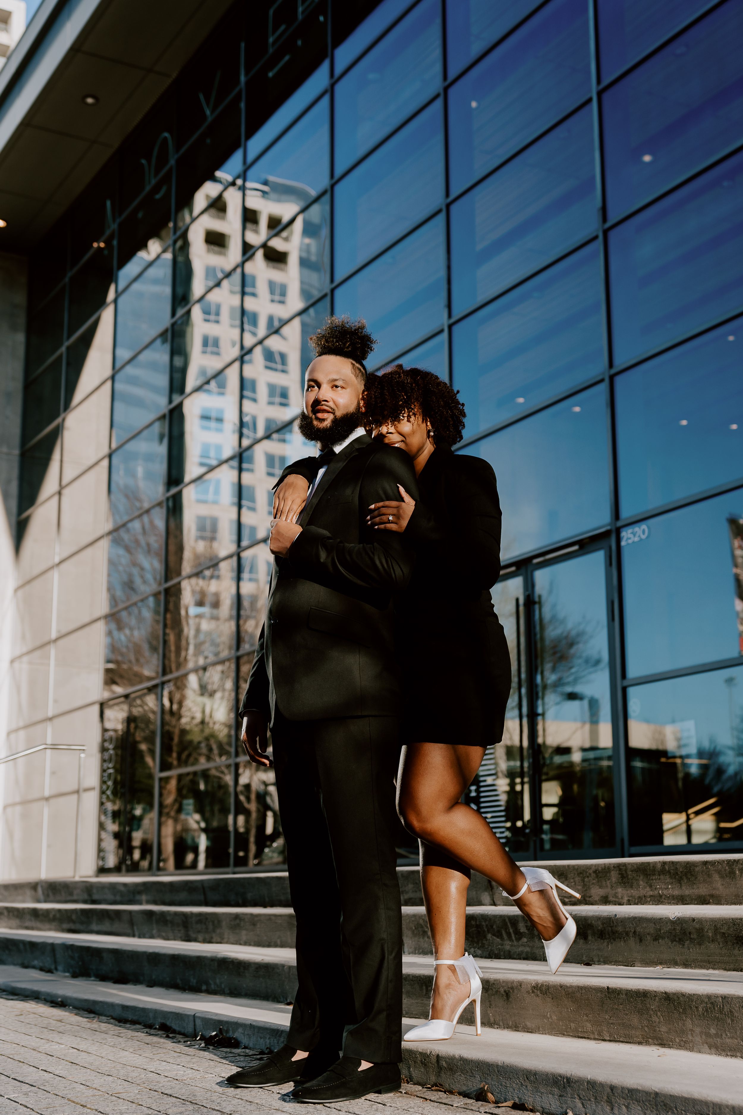 dressed up couple outside in downtown dallas. engaged couple downtown dallas. alex marie photography.