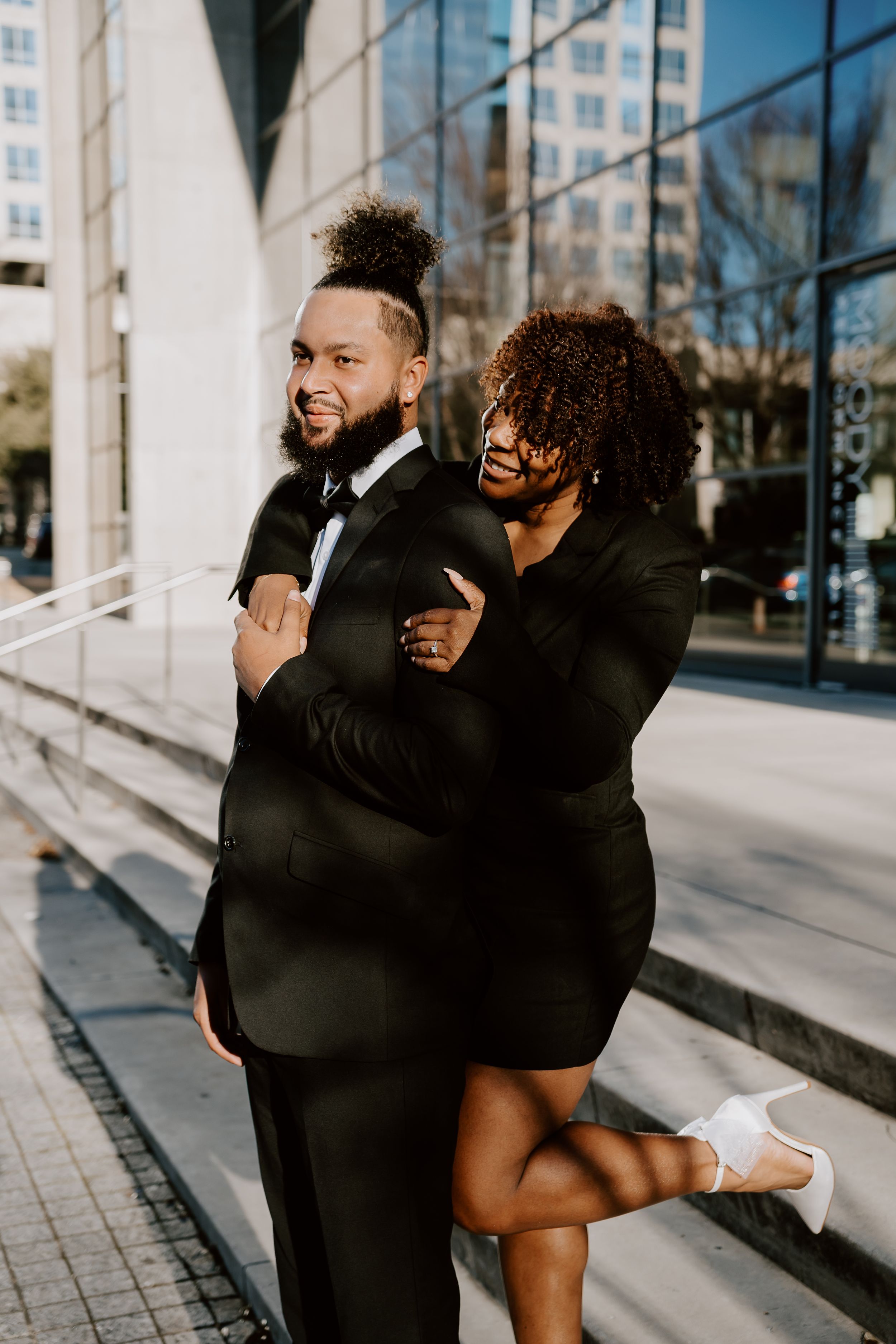 engaged couple outside downtown dallas texas. fancy couple outside engagement photoshoot at&t performance center.