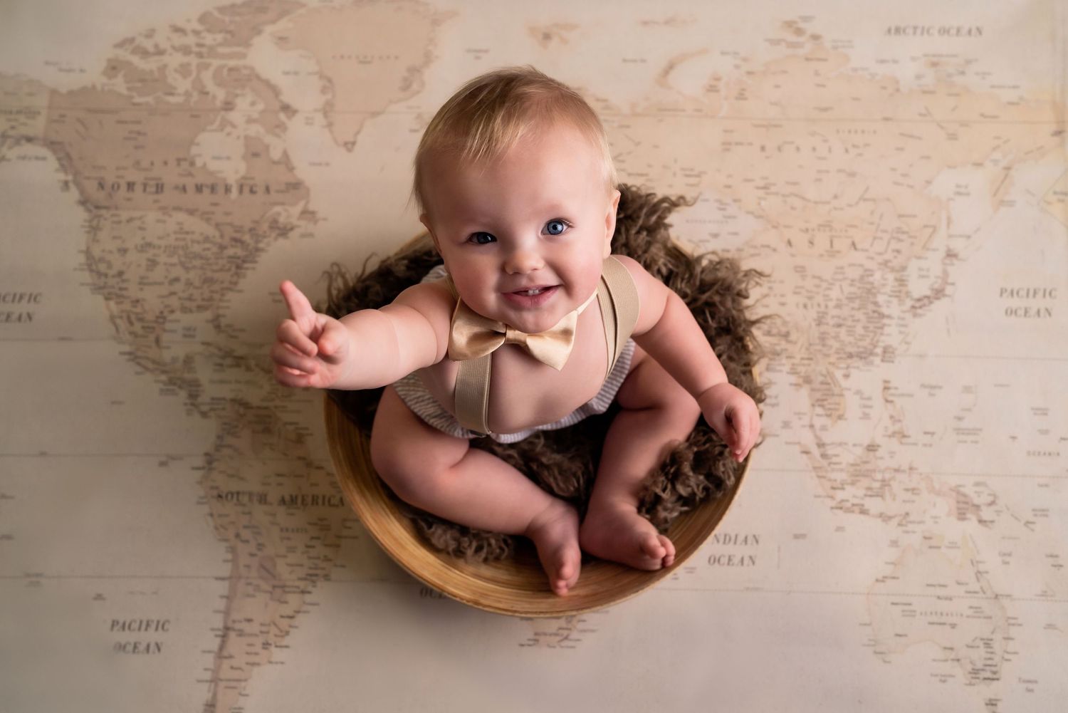 World Traveler Toddler enjoying a 1st birthday cake smash session in a Bothell studio. birthday photography by Filling the Frame Photography