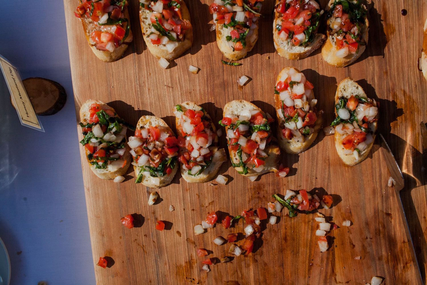 Appetizers arranged on wooden serving boards at a catered event.