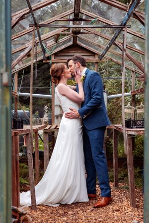 Lake District Wedding at Lindeth Howe Hotel - Helen and Danny Embrace in the Greenhouse