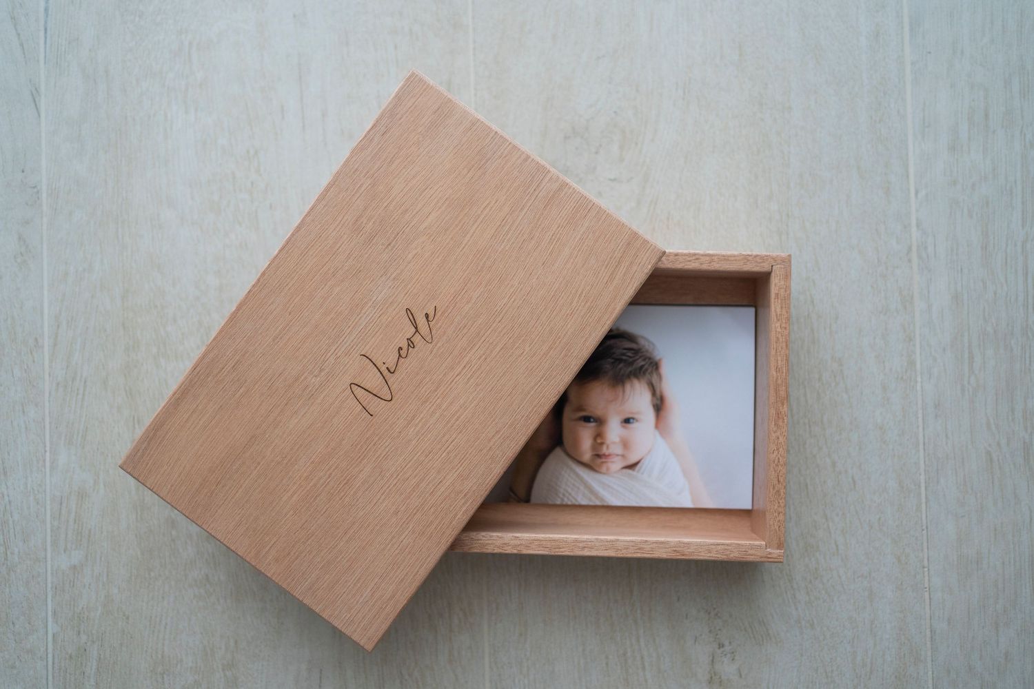 Personalized wooden keepsake box with engraved name holding a smiling child portrait photo print.