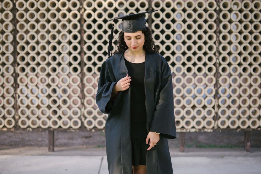 graduated girl holding her cape. UTRGV session. Edinburg, Texas. wedding photography