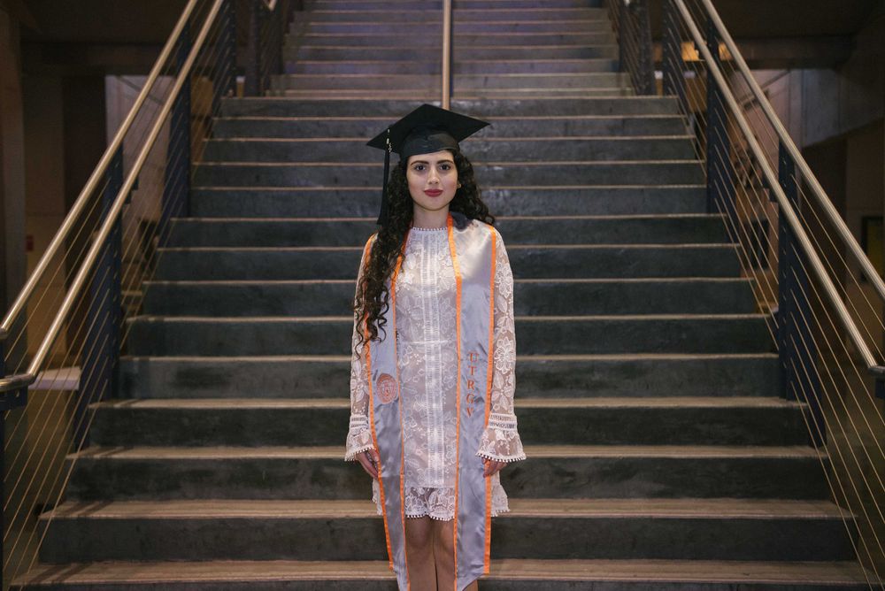 graduated in white dress in front of stairs. UTRGV session. Edinburg, Texas. wedding photography