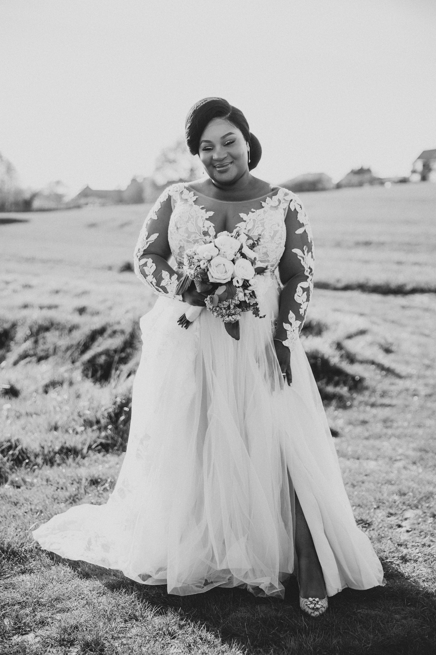 Black and white wedding photos of a bride in a flowing white dress holding a bouquet in a field.