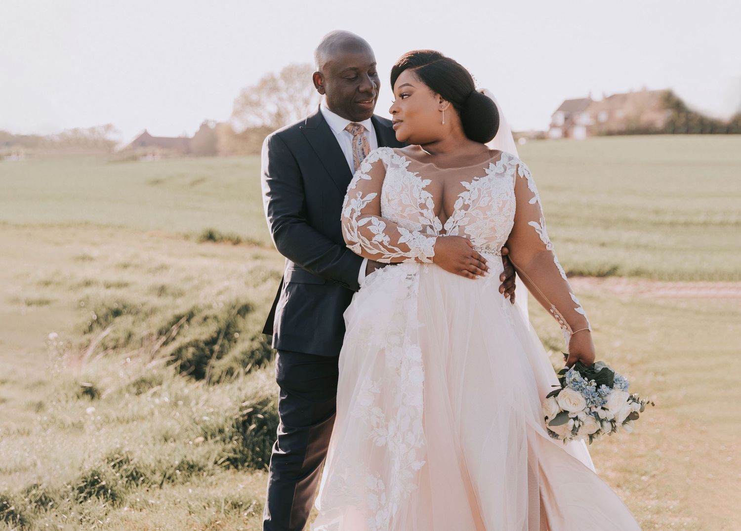 A candid wedding moment captured outdoors with natural lighting and scenic backdrop.