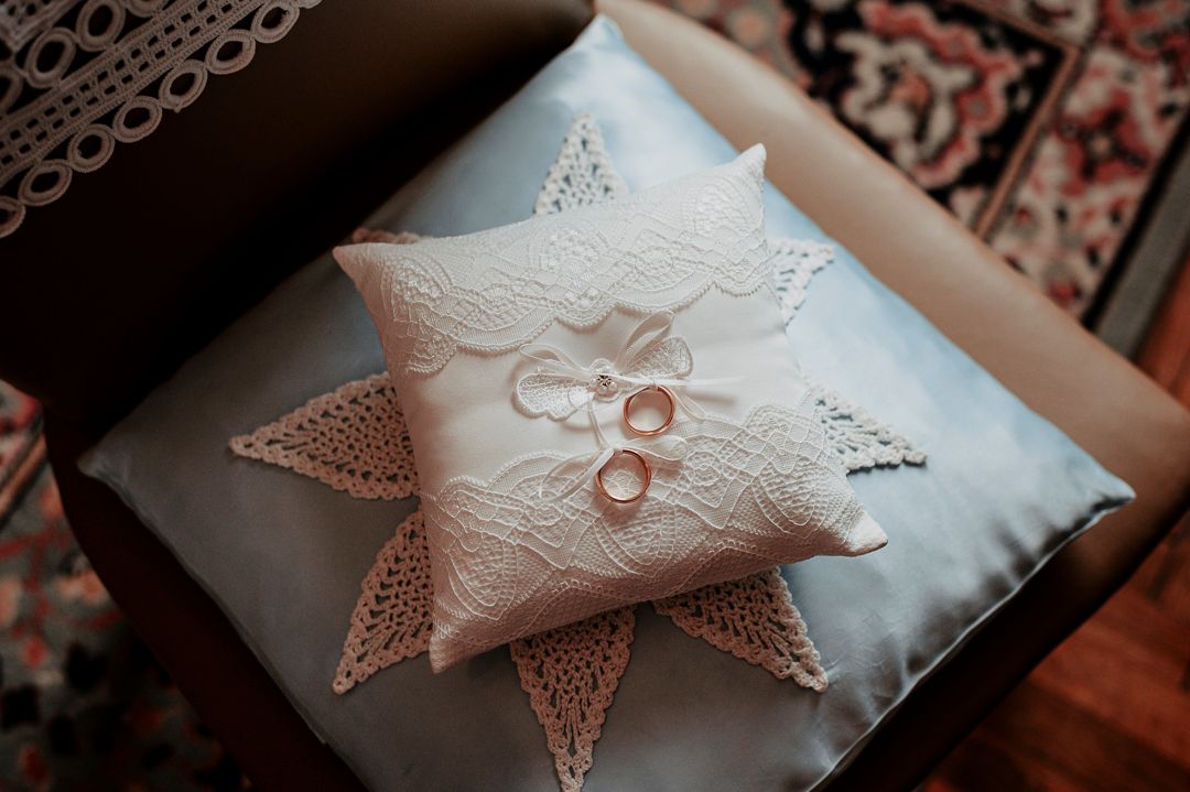 Decorative white lace ring pillow in star shape with delicate details.