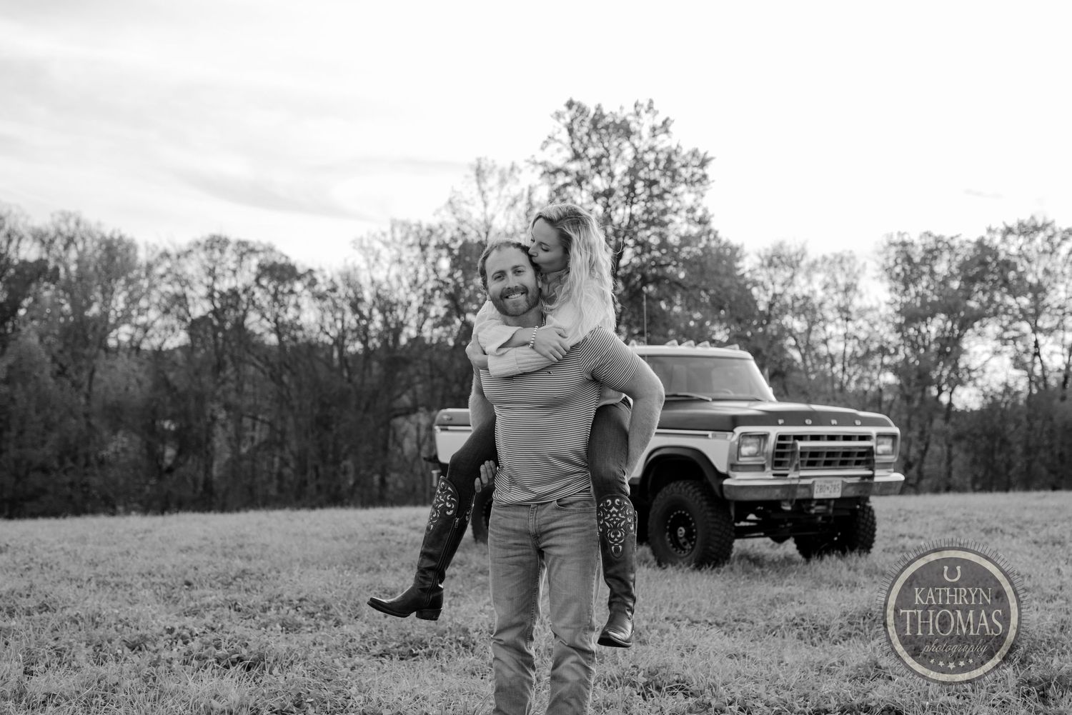 Black and white countryside portrait with a classic Ford truck in the background.