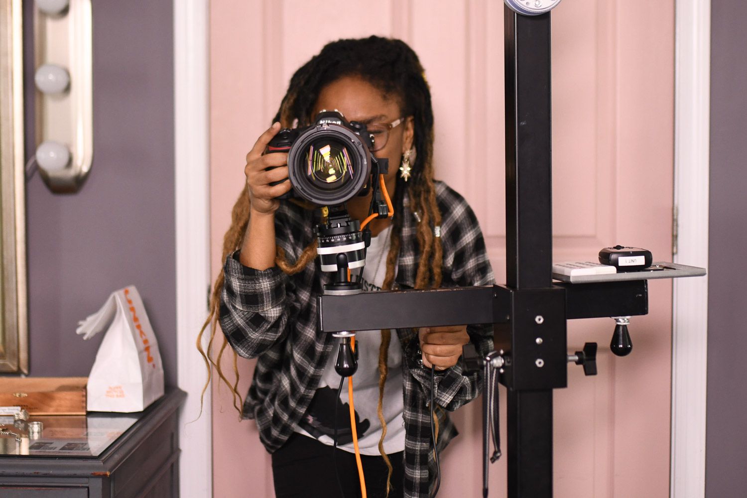 African American photographer looking through the lens.