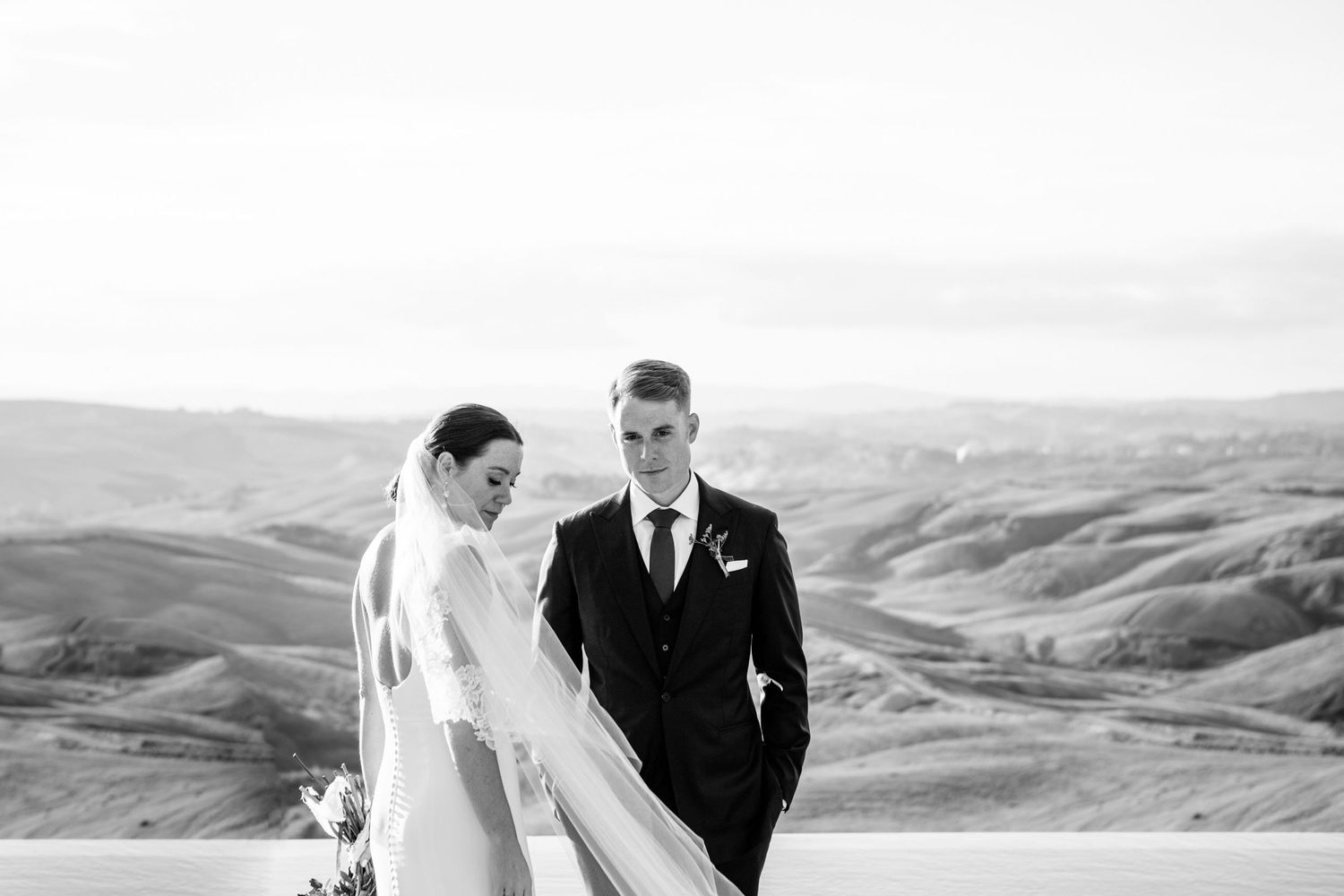 Modern black and white wedding portraits at the Lazy Olive in Tuscany with the hills of Siena as the backdrop.
