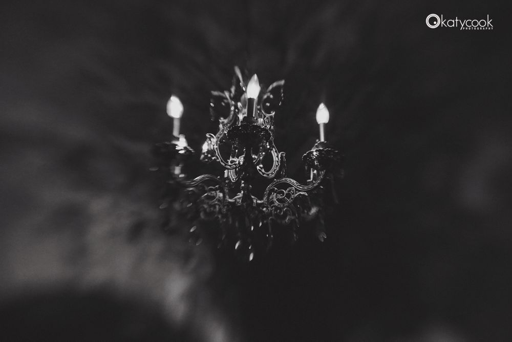 Interior wedding venue with elegant chandeliers in black and white.