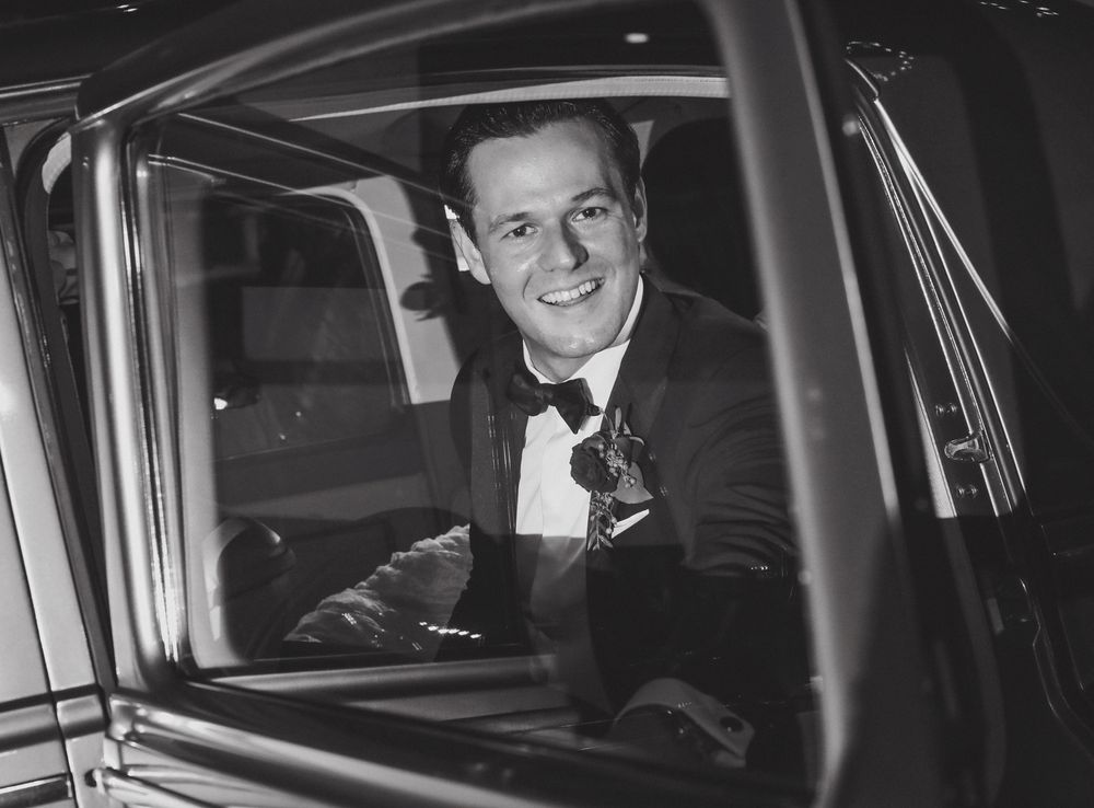 Classic black car interior shown at night with leather seats.