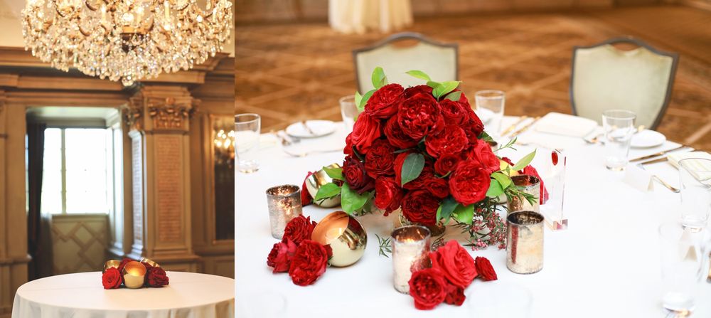 Elegant table settings with red roses and crystal chandeliers at wedding reception.