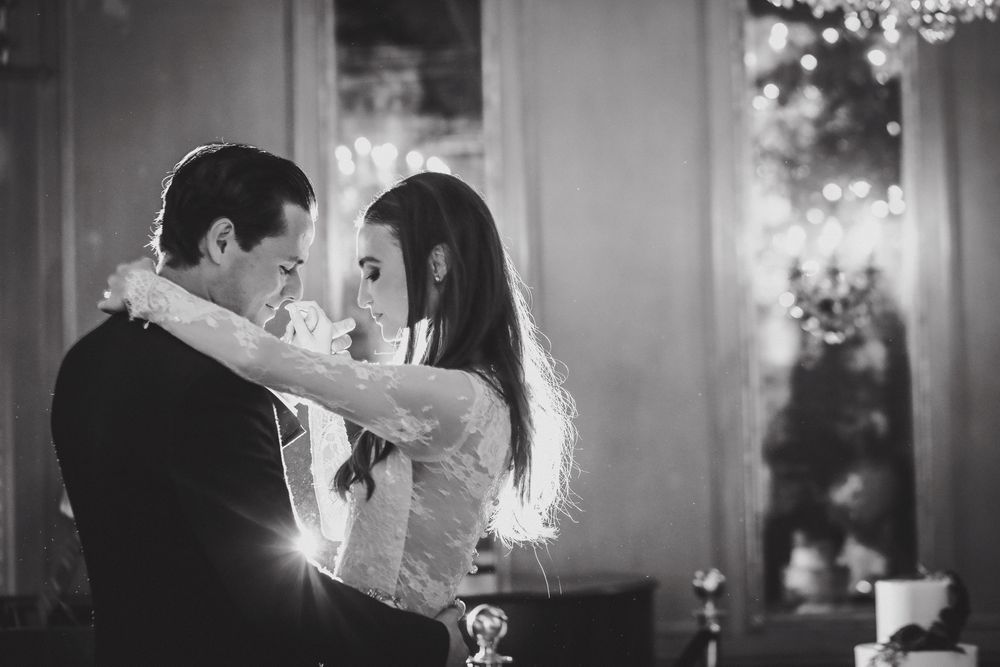 Romantic black and white photo of couple dancing at elegant reception.