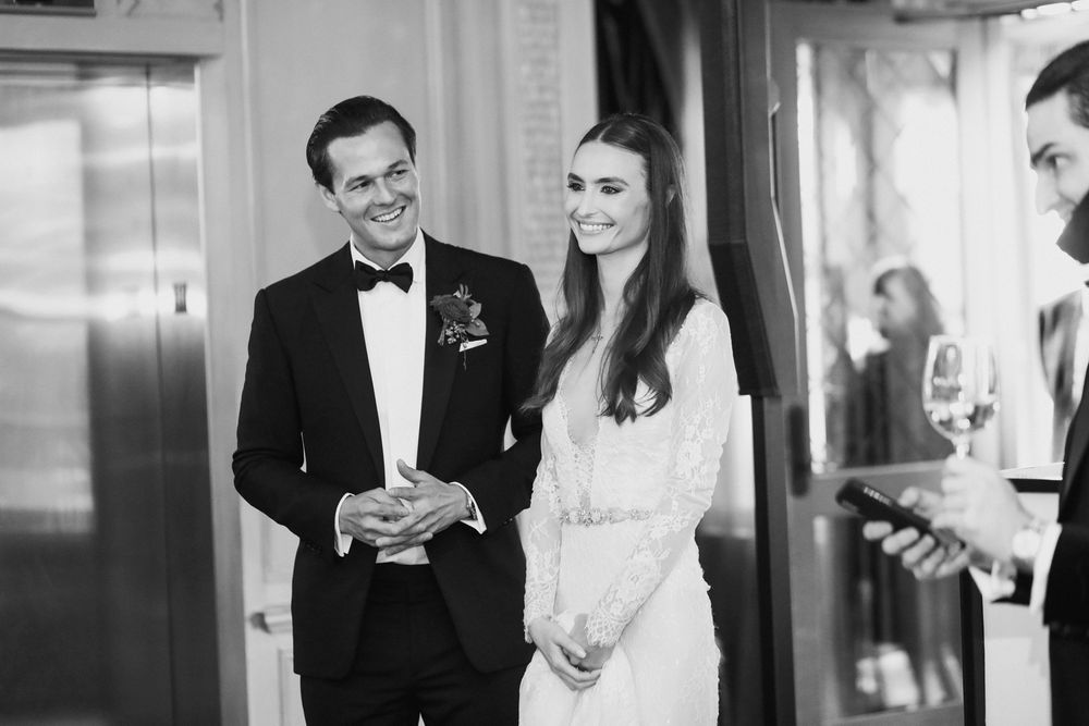 Elegant couple in formal attire at wedding reception.