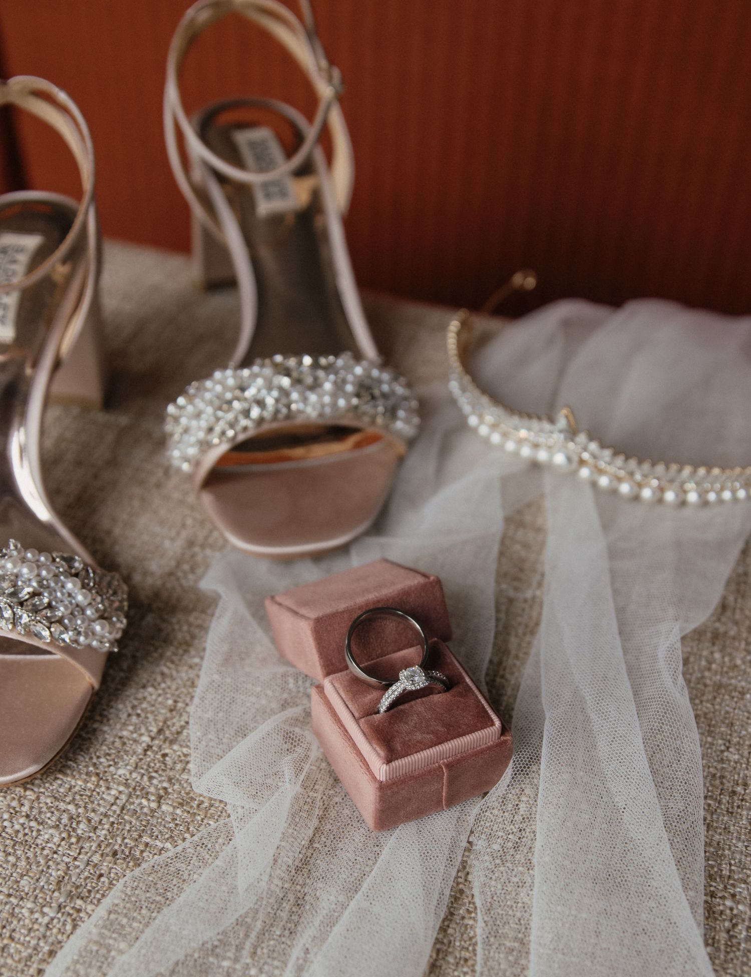 Detail shot of bride and grooms rings and Brides shoes and crown