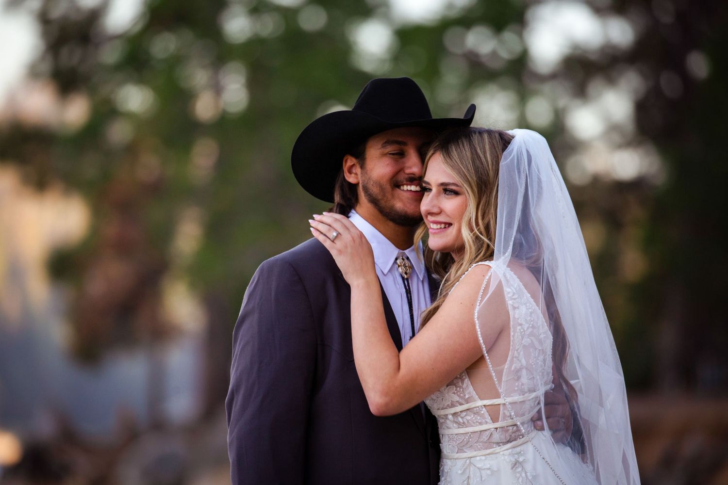 A romantic wedding photo collage showing couples embracing outdoors during a rustic countryside celebration.