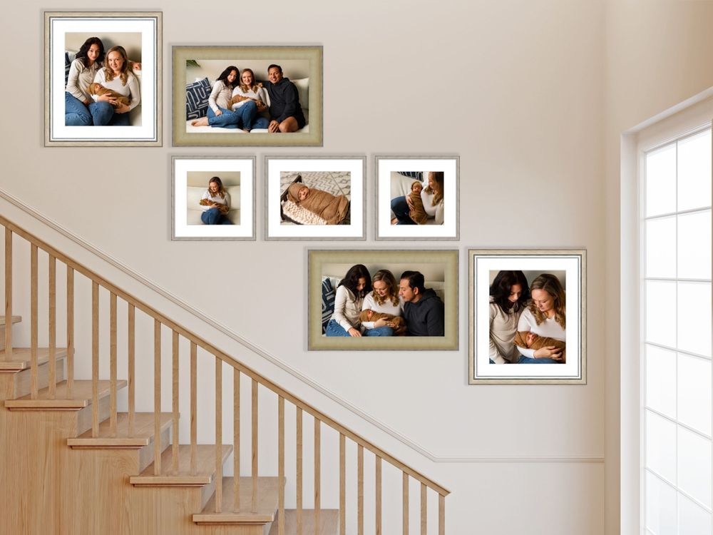 Gallery wall of family photographs arranged along staircase with wooden banister.